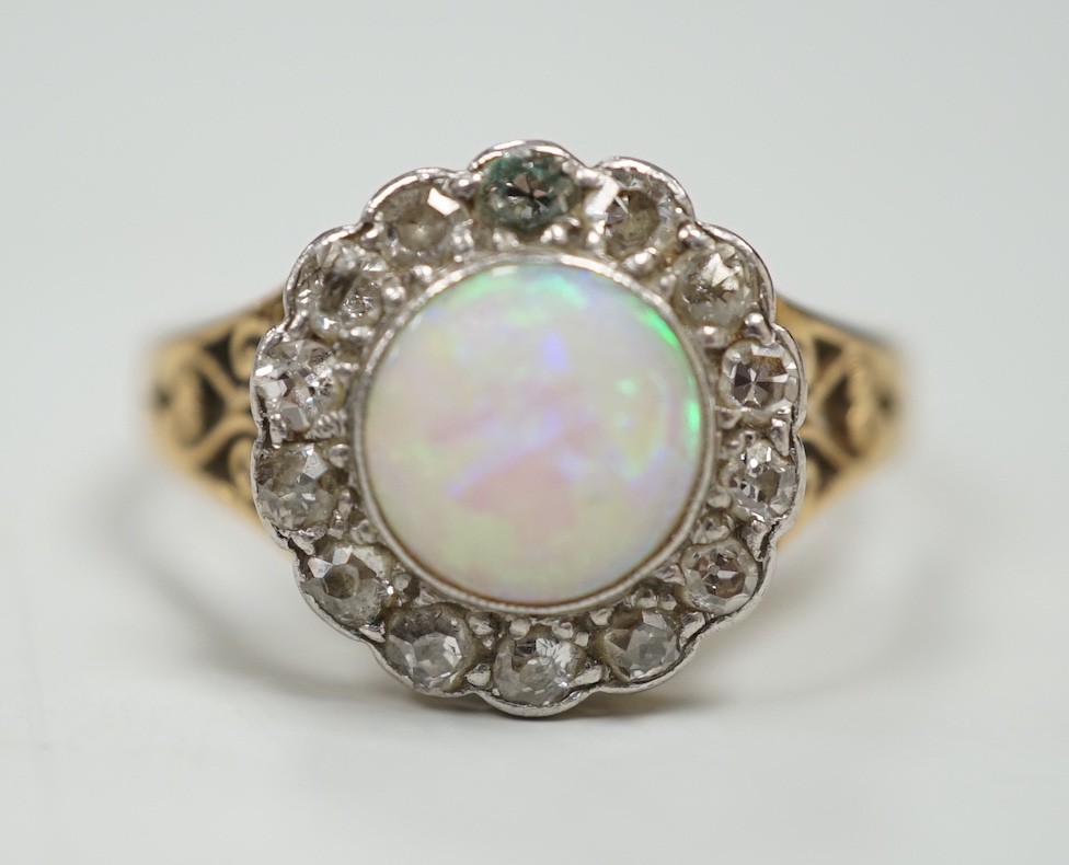 A 1920's? yellow metal, white opal and round cut diamond set circular cluster ring, size O, gross weight 3.6 grams.